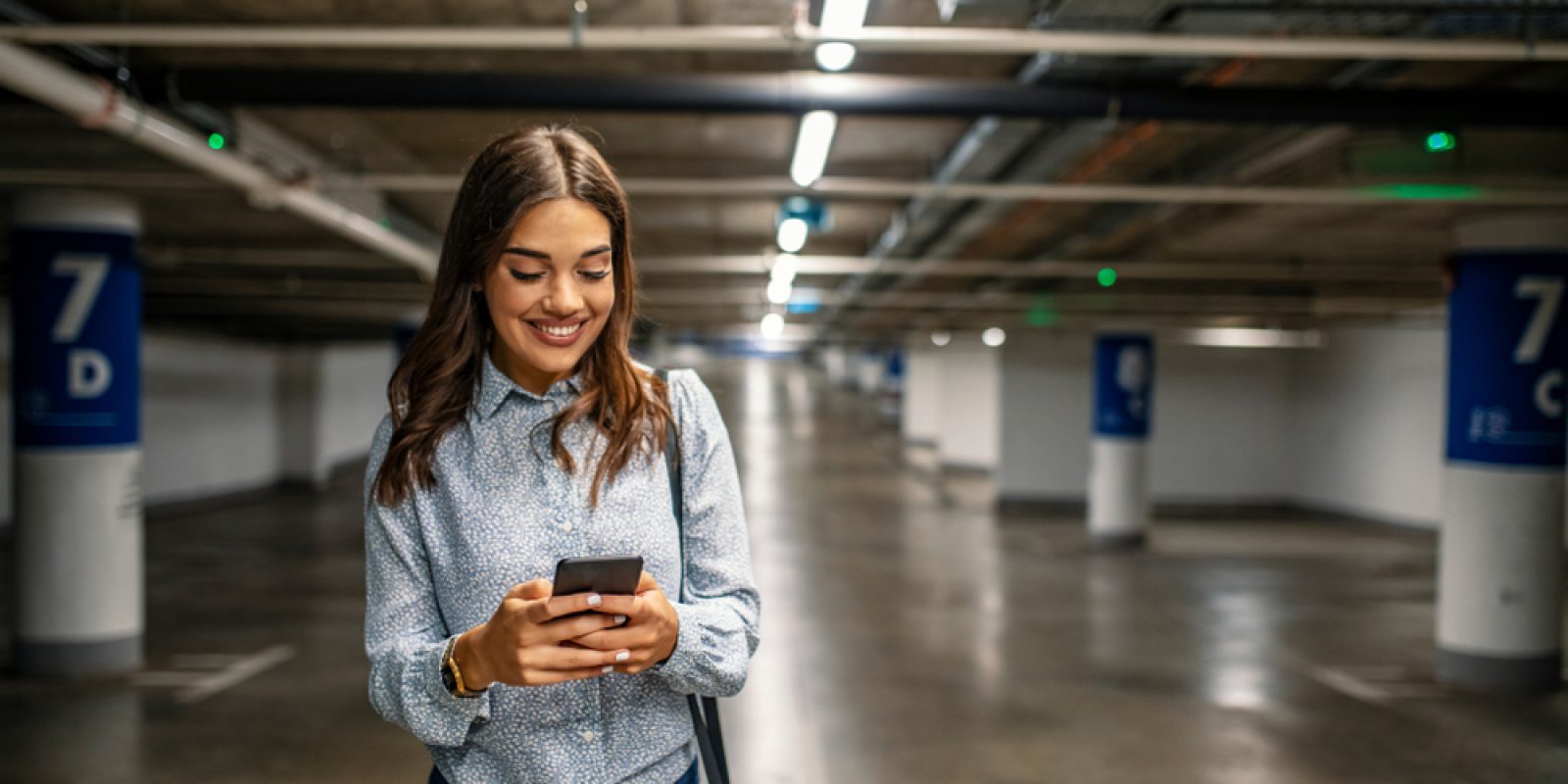 Businesswoman,In,Underground,Garage.,Elegant,Woman,Using,Smartphone,In,Parking